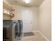 The laundry room is equipped with modern washer and dryer, plus a convenient storage shelf at 1430 October Oak Ave, Las Vegas, NV 89123