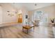 Bright living room with an open floor plan, wood floors, high ceilings, and an arched entryway at 1430 October Oak Ave, Las Vegas, NV 89123