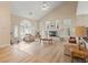 Open living room featuring high vaulted ceilings, a fireplace, wood floors, and elegant furnishings at 1430 October Oak Ave, Las Vegas, NV 89123