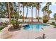 Beautiful swimming pool with palm trees and desert landscaping at 1430 October Oak Ave, Las Vegas, NV 89123