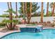 Backyard pool with spa and waterfall feature surrounded by lush foliage at 1430 October Oak Ave, Las Vegas, NV 89123