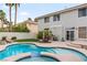 Backyard pool with adjacent spa and patio in a desert landscaped yard at 1430 October Oak Ave, Las Vegas, NV 89123