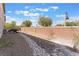 Backyard featuring a brick retaining wall, a rock-lined trench, and a BBQ grill at 150 Pocono Ranch Ave, North Las Vegas, NV 89031