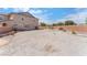 The backyard features a dirt area, a wall, and a house in the background at 150 Pocono Ranch Ave, North Las Vegas, NV 89031