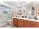 Bathroom featuring a double sink vanity with a white countertop and a shower with marble tile at 150 Pocono Ranch Ave, North Las Vegas, NV 89031