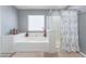 Bathroom features a large soaking tub, white trim, gray walls, and a separate shower at 150 Pocono Ranch Ave, North Las Vegas, NV 89031