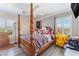 Cozy bedroom featuring a four-poster bed, wood-look flooring, and bright, sun-lit windows at 150 Pocono Ranch Ave, North Las Vegas, NV 89031