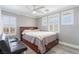 Bedroom with a ceiling fan, gray walls, wood-look floors, white trim, and lots of light at 150 Pocono Ranch Ave, North Las Vegas, NV 89031
