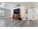 Bedroom with wood-look floors, modern trim, a large television, and access to a walk-in closet at 150 Pocono Ranch Ave, North Las Vegas, NV 89031