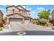 Inviting two-story home with a tandem three-car garage, neutral color palette, and a well-maintained concrete driveway at 150 Pocono Ranch Ave, North Las Vegas, NV 89031