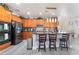 Updated kitchen with dark stainless steel appliances and a central island and breakfast bar at 150 Pocono Ranch Ave, North Las Vegas, NV 89031
