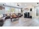 Hardwood-floored living room with natural light, large windows, surround system, and a comfortable seating area for relaxation at 150 Pocono Ranch Ave, North Las Vegas, NV 89031