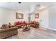 Cozy living room featuring hardwood floors, two brown sofas, and neutral walls for comfortable gatherings at 150 Pocono Ranch Ave, North Las Vegas, NV 89031