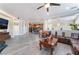 Spacious open-concept living area flowing into a kitchen with hardwood floors, neutral walls and recessed lighting at 150 Pocono Ranch Ave, North Las Vegas, NV 89031