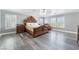 Relaxing main bedroom features white trim, wood-look floors, and an ornate wood bed at 150 Pocono Ranch Ave, North Las Vegas, NV 89031