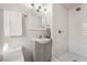 A half bath boasts gray vanity, white fixtures, and a shower with white subway tile at 1720 Hassett Ave, Las Vegas, NV 89104