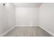 An empty bedroom with light gray vinyl floors, white walls, and natural light at 1720 Hassett Ave, Las Vegas, NV 89104