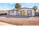 Charming single-story home featuring a freshly landscaped yard and bright yellow doors at 1720 Hassett Ave, Las Vegas, NV 89104