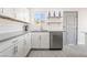 A modern kitchen featuring white cabinets, stainless steel appliances, and stylish backsplash at 1720 Hassett Ave, Las Vegas, NV 89104