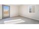 Bright living room with wood-look floors, large window, and glass panel door at 1720 Hassett Ave, Las Vegas, NV 89104