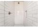 A tiled shower features white subway tiles and a brushed steel shower head at 1720 Hassett Ave, Las Vegas, NV 89104