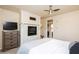 Cozy bedroom with a fireplace, ceiling fan, and a flatscreen television at 223 Hunter Ridge Rd # 300, Brian Head, UT 84719