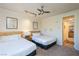 Bedroom with two beds, ceiling fan, and view to kitchen at 223 Hunter Ridge Rd # 300, Brian Head, UT 84719