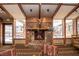 Cozy stone fireplace with mounted deer head in a well-lit lounge area at 223 Hunter Ridge Rd # 300, Brian Head, UT 84719