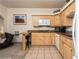 Kitchen with wood cabinets, granite counters, and view of the living area at 223 Hunter Ridge Rd # 300, Brian Head, UT 84719