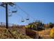 Low angle of ski lift chairs with a stone brick wall and fence in the foreground, trees behind the chairlift at 223 Hunter Ridge Rd # 300, Brian Head, UT 84719