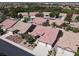 An aerial view of a home with a red tile roof in a well-manicured community at 2251 Summerwind Cir, Henderson, NV 89052