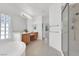 Bright bathroom featuring a soaking tub, glass block window, and walk-in shower at 2251 Summerwind Cir, Henderson, NV 89052