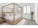 Bright bedroom featuring a four-poster bed, neutral decor and ample natural light at 2251 Summerwind Cir, Henderson, NV 89052
