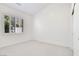 Bright bedroom features neutral carpet, white walls, and window with plantation shutters at 2251 Summerwind Cir, Henderson, NV 89052