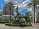 Artistic courtyard sculpture surrounded by shops, palm trees, and manicured landscaping under a bright sky at 2251 Summerwind Cir, Henderson, NV 89052