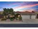Beautiful single story home featuring a three car garage and desert landscaping at 2251 Summerwind Cir, Henderson, NV 89052