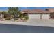 Well-maintained single-story home with a three-car garage, desert landscaping, and a red tile roof at 2251 Summerwind Cir, Henderson, NV 89052