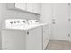 Laundry room features a washer, dryer and overhead cabinets at 2251 Summerwind Cir, Henderson, NV 89052
