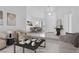 Bright living room with modern furnishings, neutral decor, and seamless flow to dining area at 2251 Summerwind Cir, Henderson, NV 89052