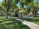 Community playground with mature trees, benches, and sidewalks at 2251 Summerwind Cir, Henderson, NV 89052