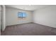 Empty bedroom with plush carpeting and a window to let in natural sunlight at 2636 Lily Point St, Las Vegas, NV 89156