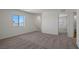 Spacious carpeted bedroom with a large window offering views and bright natural light at 2636 Lily Point St, Las Vegas, NV 89156