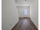 Bright entryway with wood-look flooring, white walls, and a frosted glass front door and window to the side at 2636 Lily Point St, Las Vegas, NV 89156