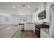 Bright kitchen features white cabinets, stainless steel appliances, and an island with countertop seating at 2636 Lily Point St, Las Vegas, NV 89156