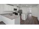 Lovely kitchen featuring stainless steel appliances, stone countertops, white cabinets and an island with seating at 2636 Lily Point St, Las Vegas, NV 89156