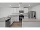Modern kitchen featuring stainless steel appliances, stone countertops and white cabinets and an island sink at 2636 Lily Point St, Las Vegas, NV 89156