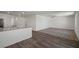 Large living room space with wood-look flooring, neutral carpet, ceiling fan and windows at 2636 Lily Point St, Las Vegas, NV 89156