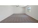 Spacious living room featuring neutral carpet, white walls, a ceiling fan and a large picture window at 2636 Lily Point St, Las Vegas, NV 89156