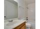 Bathroom with a tub, toilet, large mirror, single vanity, and tiled walls at 2681 Ruthe Duarte Ave, Las Vegas, NV 89121