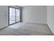 Spacious bedroom with neutral carpet, tile accent, and sliding glass doors leading to a balcony at 2681 Ruthe Duarte Ave, Las Vegas, NV 89121